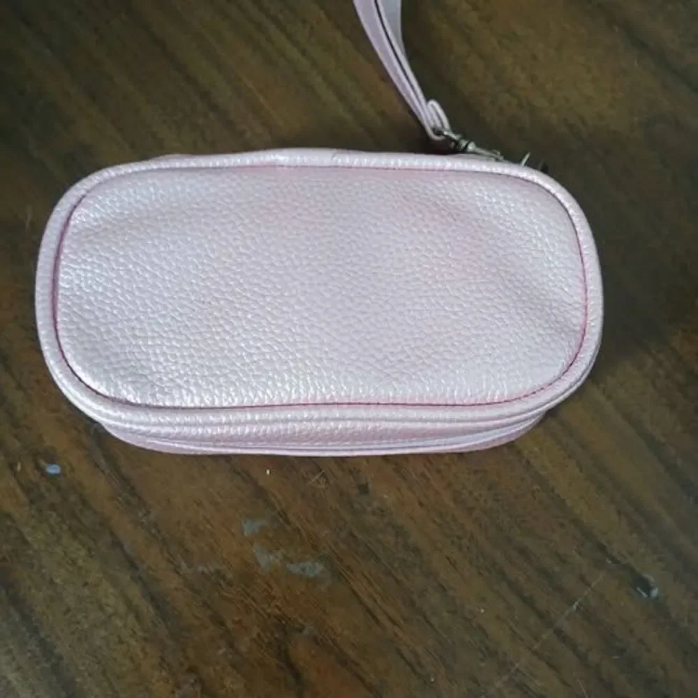 7-day pill organizer designed for use twice daily, w/ pink leather bag